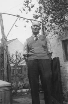 Dad in back yard of shop.