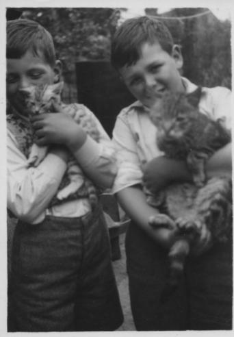 Mick with Charlie and Colin with Smokey in back yard early 1950s.